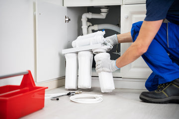 An image of a reverse osmosis water filtration system being installed by a water treatment professional. Our Met Pro Wholesale Business Program has all the supplies you need as a plumber, water treatment company or appliance installer. 
